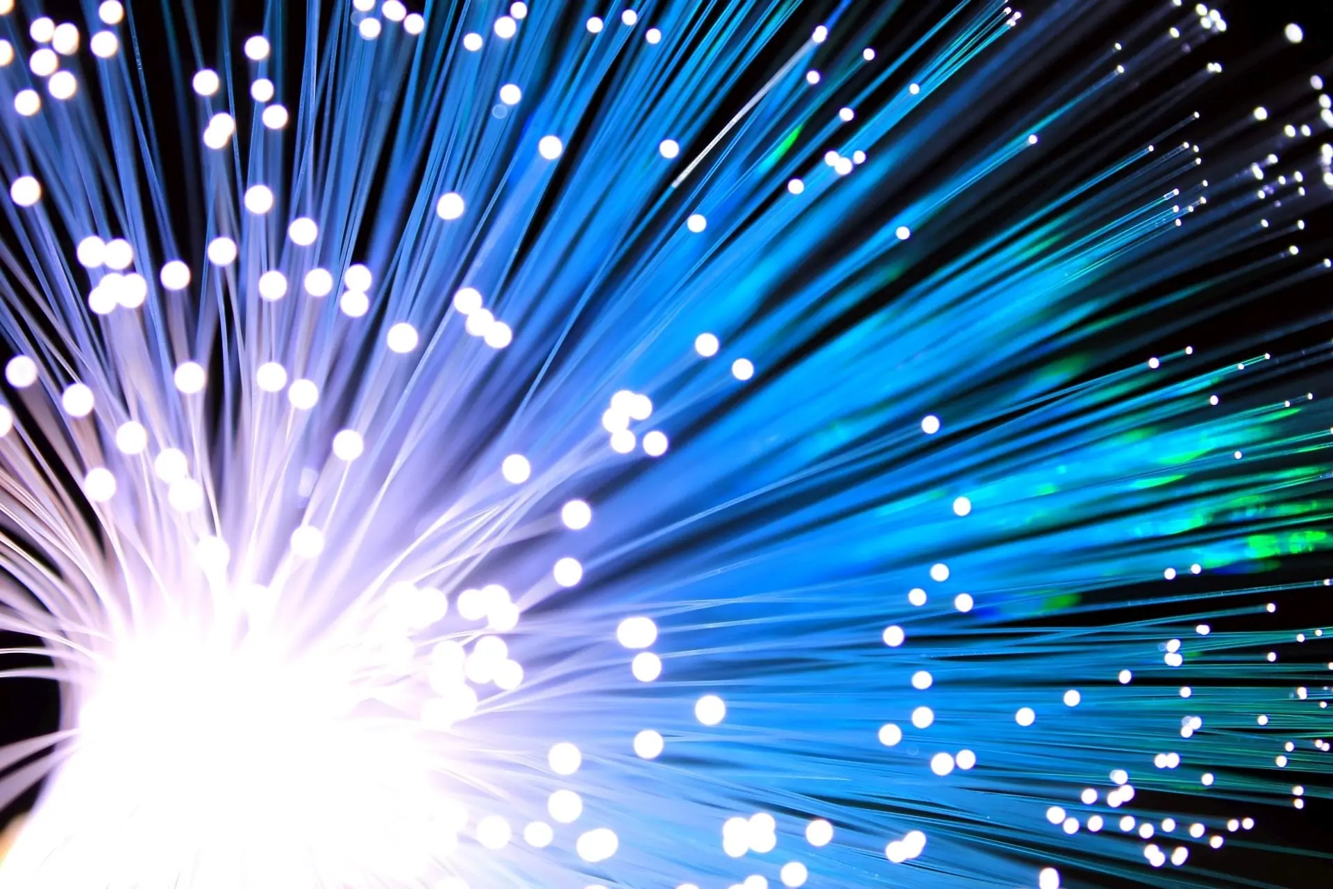 Glowing blue fiber-optic strands fanning out toward the camera